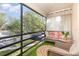 Cozy screened patio with comfortable seating overlooking lush greenery, offering a serene outdoor retreat at 5666 Gardens Dr # 202, Sarasota, FL 34243