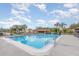 Inviting community pool surrounded by lounge chairs and palm trees, providing a relaxing oasis for residents at 5666 Gardens Dr # 202, Sarasota, FL 34243