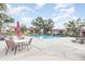 Community pool with lounge chairs and tables, perfect for relaxation and social gatherings at 5666 Gardens Dr # 202, Sarasota, FL 34243