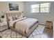 Serene bedroom featuring a tufted headboard bed, decorative pillows, and a stylish area rug at 5970 80Th N St # 204, St Petersburg, FL 33709