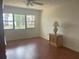 Bedroom showcasing laminate floors and a window view to green space and mature trees at 5970 80Th N St # 204, St Petersburg, FL 33709
