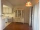 Cozy dining area featuring a vintage hutch, adjacent to a compact kitchen and balcony access at 5970 80Th N St # 204, St Petersburg, FL 33709