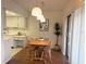 Inviting dining area featuring a wooden table set, pendant lighting, and access to the outdoors at 5970 80Th N St # 204, St Petersburg, FL 33709