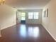 Spacious living room with hardwood floors and a large window providing ample natural light at 5970 80Th N St # 204, St Petersburg, FL 33709