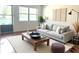 Cozy living room boasts a plush sofa, stylish coffee table, and ample natural light from the window at 5970 80Th N St # 204, St Petersburg, FL 33709