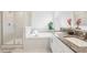 Elegant bathroom features a soaking tub, a separate shower, and double sinks with granite countertops at 6398 Bar S Bar Trl, Zephyrhills, FL 33541