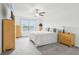 Well-lit bedroom features carpet, a ceiling fan, and a coordinated furniture set that offers lots of storage at 6398 Bar S Bar Trl, Zephyrhills, FL 33541