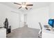 Neutral bedroom with ceiling fan, closet, and carpet; an ideal blank canvas for personalized decor at 6398 Bar S Bar Trl, Zephyrhills, FL 33541