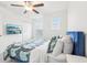 Bright bedroom features a ceiling fan, and two windows that flood the room with natural light at 6398 Bar S Bar Trl, Zephyrhills, FL 33541