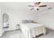 Bright bedroom features neutral color scheme, closet, ceiling fan, and minimalist decor, creating a calm and relaxing atmosphere at 6398 Bar S Bar Trl, Zephyrhills, FL 33541