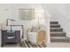 Inviting entryway with a comfortable chair, side table, changing table and a staircase at 6398 Bar S Bar Trl, Zephyrhills, FL 33541