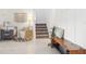 Bright entryway with white walls, decorative rug, a plant and a staircase leading upstairs at 6398 Bar S Bar Trl, Zephyrhills, FL 33541