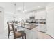 Modern kitchen with stainless steel appliances, a granite-topped island and pendant lighting at 6398 Bar S Bar Trl, Zephyrhills, FL 33541