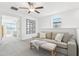 Bright living room features a ceiling fan, neutral color scheme, and cozy seating arrangement, creating an inviting space at 6398 Bar S Bar Trl, Zephyrhills, FL 33541