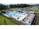 Stunning aerial view of the community pool, highlighted by ample lounge areas and lush landscaping at 6398 Bar S Bar Trl, Zephyrhills, FL 33541