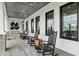 Inviting covered porch with rocking chairs, offering a relaxing outdoor space for leisure and enjoyment at 6398 Bar S Bar Trl, Zephyrhills, FL 33541