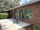 Back exterior of brick house. Patio with two chairs at 6533 Brentwood Dr, Zephyrhills, FL 33542