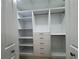 Large, white walk-in closet featuring shelves, hanging rods, drawers and ample space for storage at 6533 Brentwood Dr, Zephyrhills, FL 33542