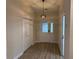 Foyer of home has tile flooring and a decorative light fixture at 6533 Brentwood Dr, Zephyrhills, FL 33542