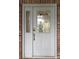 Front door is detailed with glass windows at 6533 Brentwood Dr, Zephyrhills, FL 33542