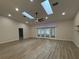 Living Room boasts high ceilings, skylights, a ceiling fan, and access to back patio at 6533 Brentwood Dr, Zephyrhills, FL 33542