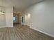 Spacious living room with light colored walls and floors. Entryway and front door in view at 6533 Brentwood Dr, Zephyrhills, FL 33542