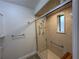 Shower with glass doors, a bench, and safety bars for easy access at 6533 Brentwood Dr, Zephyrhills, FL 33542