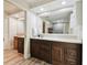 Bathroom featuring dual vanities, wood cabinets, large mirrors, and modern fixtures at 6703 Towhe Dr, Seffner, FL 33584