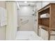 Tiled walk-in shower with a glass door, built-in shelves, and modern fixtures at 6703 Towhe Dr, Seffner, FL 33584