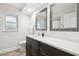 Bathroom featuring dark wood cabinets, modern fixtures, and decorative mirrors at 6703 Towhe Dr, Seffner, FL 33584