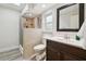 Bright bathroom featuring a tile shower with a shower curtain and a dark vanity at 6703 Towhe Dr, Seffner, FL 33584