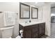 Bathroom featuring dark wood cabinets, modern fixtures, and decorative mirrors at 6703 Towhe Dr, Seffner, FL 33584