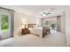 Inviting bedroom with natural light, ceiling fan, and a view to the screened patio at 6703 Towhe Dr, Seffner, FL 33584