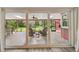 View from living room of covered patio with cozy seating and backyard views at 6703 Towhe Dr, Seffner, FL 33584