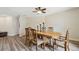 Inviting dining area features wood table and chairs, stylish light fixture and light, neutral color palette at 6703 Towhe Dr, Seffner, FL 33584