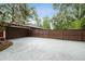 Long driveway leading to a home, enclosed by a stained wood fence and lush trees at 6703 Towhe Dr, Seffner, FL 33584
