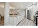 Open kitchen featuring an island, stainless steel appliances, and wood-look flooring at 6703 Towhe Dr, Seffner, FL 33584