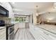 Open kitchen featuring an island, stainless steel appliances, and granite countertops at 6703 Towhe Dr, Seffner, FL 33584