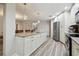 Open kitchen featuring an island, stainless steel appliances, and wood-look flooring at 6703 Towhe Dr, Seffner, FL 33584