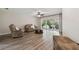 Cozy living room with vinyl floors and sliding door access to a covered patio at 6703 Towhe Dr, Seffner, FL 33584