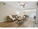 Inviting living room features wood-look floors with a ceiling fan and comfortable furnishings at 6703 Towhe Dr, Seffner, FL 33584