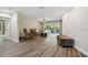Comfortable living room with vinyl floors, ceiling fan and access to a covered patio at 6703 Towhe Dr, Seffner, FL 33584