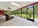 Spacious screened-in patio with a ceiling fan and views of the expansive, well-maintained backyard at 6703 Towhe Dr, Seffner, FL 33584