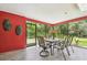 Enjoy the outdoors from this enclosed patio with a table and chairs, and view of the backyard at 6703 Towhe Dr, Seffner, FL 33584