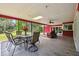 Relax in the enclosed lanai with tiled floors, a ceiling fan, and a scenic view of the backyard at 6703 Towhe Dr, Seffner, FL 33584