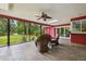 Enjoy outdoor living in the screened-in patio with wicker chairs and views of the backyard at 6703 Towhe Dr, Seffner, FL 33584