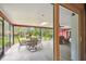 A screened in patio with table and chairs, tiled flooring, and a beautiful view of the backyard at 6703 Towhe Dr, Seffner, FL 33584