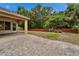 The backyard has a stone patio and privacy fence at 6801 Bishops Pointe Way, Riverview, FL 33578