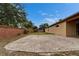 Backyard with stone patio, lawn, and brick perimeter wall for privacy at 6801 Bishops Pointe Way, Riverview, FL 33578