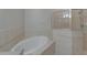 Bright bathroom features a soaking tub and a separate glass-enclosed shower at 6801 Bishops Pointe Way, Riverview, FL 33578